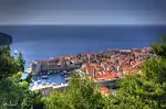 Marina in a city with churches and a fort.