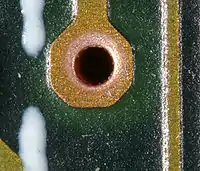 Plated-through holes, in this section there are eight on a multilayer board (magnified)