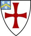 Shield of Durham University: Argent, a cross paty quadrate gules; on a canton azure a chevron or between three lions rampant argent.