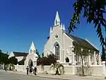 Very fine Cape Gothic church, rectangular in plan with small Gothic tower to street elevation.
Also fine Gothic entrance gate.
Now painted white, previously colour-washed with details picked out.
This church building was designed in the neo-Gothic style by Carl Otto Hager, the well-known architect.
Hager also supervised its erection, which was completed about 1864.
Type of site: Church
Previous use: Church.
Current use: Flower displays.
This church building was designed in the neo-Gothic style by Carl Otto Hager, the well-known architect.
Hager also supervised its erection, which was completed about 1864.