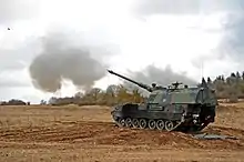 German soldiers with 4th Battery, 131st Artillery Battalion carry out a fire mission with self propelled howitzers.