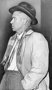 A black-and-white photo of Cummings standing in profile