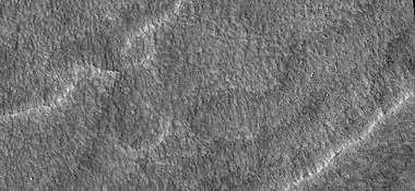 Close-up of scalloped ground, as seen by HiRISE under HiWish program.  Surface is divided into polygons; these forms are common where ground freezes and thaws.  Note: this is an enlargement of a previous image.