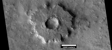 Pedestal crater, as seen by HiRISE under HiWish program.  Top layer has protected the lower material from being eroded.  The location is Casius quadrangle.