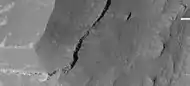 Enlargement of edge of mesa on floor of Noctis Labyrinthus showing layers, as seen by HiRISE under HiWish program  Note: this is an enlargement of a previous image.