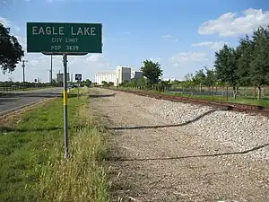 City limit sign with Eagle Lake Rice Dryer in the background