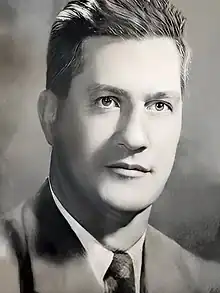 Restored black and white head and shoulders photo of Earle B. McLaughlin, facing front, looking slightly right, circa 1958