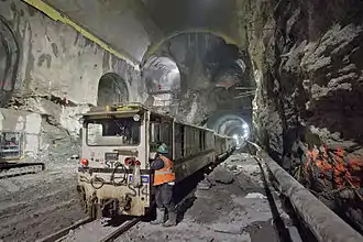 Cavern excavated as part of East Side Access, with a work train in the foreground that is dwarfed by the immensity of the freshly carved cavern.