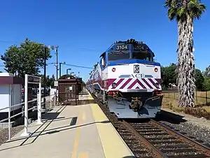 An eastbound train leaving Pleasanton station