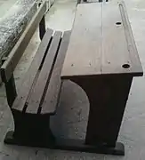 French school desks, c. 1900. The holes for the student's inkwells can be seen