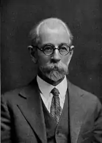 black and white portrait of older man with beard and mustache