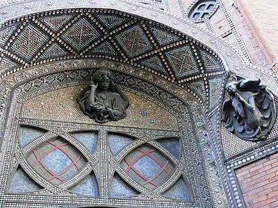 Detail of ceramic decoration and sculpture of the portal.