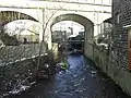 Elphin Brook passing under the Caldervale Line railway viaduct