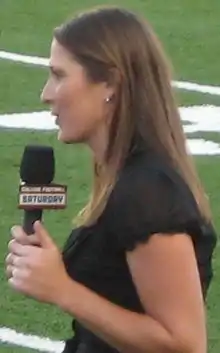 female reporter holding microphone