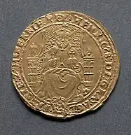 Gold coin showing a man seated on a chair