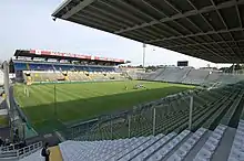 A view of a football pitch and the stands surrounding it from the view of one corner.