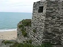 Overgrown concrete structure on beach