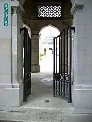 View through the entrance to the Indian Memorial to the Missing at Neuve Chapelle. In the distance is  one of the memorial's two Chattri.