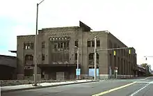 Large, rectangular building with several broken windows