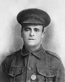 a head and shoulders photograph of a soldier in military uniform