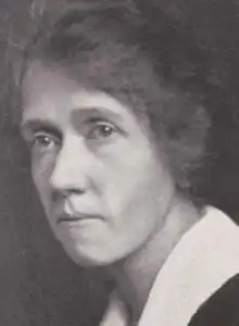 A yearbook photograph of a middle-aged white woman wearing a large white collar; she is not smiling