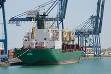 A green-and-white cargo ship