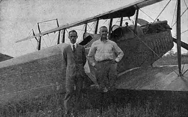 Lt. Macready (right) and McCook Field engineer E. Dormoy (left) in front of the 1st crop duster airplane (August 3, 1921)