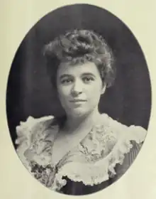 A young white woman with curled hair, in an oval frame