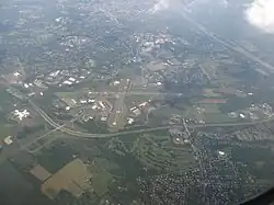 Aerial view of Ewing, looking southeast and featuring Trenton–Mercer Airport, Interstate 295, and the Delaware River