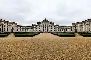 Large symmetrical palace complex with white walls.