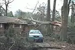 This house only sustained minor loss of shingles. Though well-built structures are typically unscathed by F0 tornadoes, falling trees, and tree branches can injure and kill people, even inside a sturdy structure.