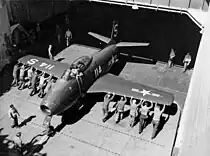 Boxer's crew pushing a FJ-1 Fury from the ship's elevator in 1948