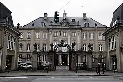 photograph of a large three-story manor house with iron railings