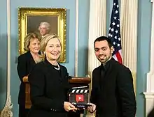 Farbod Khoshtinat receiving the democracy video award from the US secretary of state Hillary Clinton, September 2010