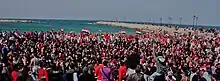 Seaside demonstration, with protesters wearing red, white and blue