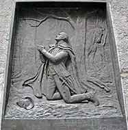 Brass relief of Washington kneeling in prayer