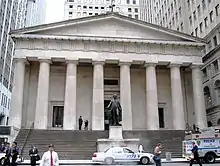 Neoclassical building with doric columns and a statue of George Washington