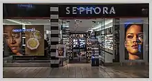 A Sephora storefront with large posters showing two close-up photos of Rihanna and one Fenty Beauty cosmetic item