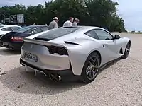 Rear 3/4 view showing quad tail lights and body-colored diffuser