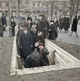 Finnish civilians enter a bomb shelter in Helsinki during the Winter War, 1939