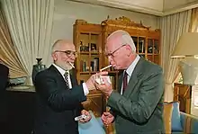 King Hussein lights Yitzhak Rabin's cigarette at the royal residence in Aqaba, shortly after the signing of the peace treaty, 26 October 1994