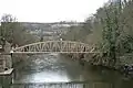 Most of the development on one side of the valley - footbridge over River Derwent