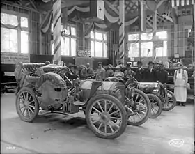 In foreground, the Shawmut that won the 1909 Ocean to Ocean Automobile Endurance Contest; behind that, the Model T that was disqualified, displayed at the 1909 Alaska-Yukon-Pacific Exposition in Seattle.