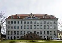 A large four storey building with red roof