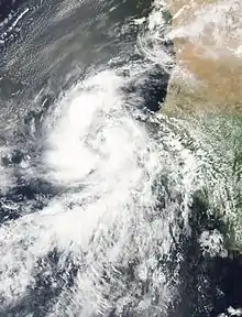 A satellite image shows Fred as an intensifying tropical storm, situated right between the Cape Verde Islands and the coast of West Africa. The storm is supporting robust thunderstorm clouds, arranged in two prominent bands.