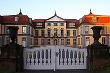 The symmetrical structure of Schloss Friedrichsthal, seen through the front gate to the property