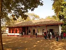 People in front of an ashram building