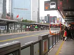 Passengers and a bus at a station