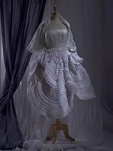 White mid-length dress displayed on a mannequin