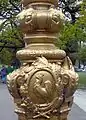 Detail of a lamppost in the square, featuring the Gallic rooster, national symbol of France.